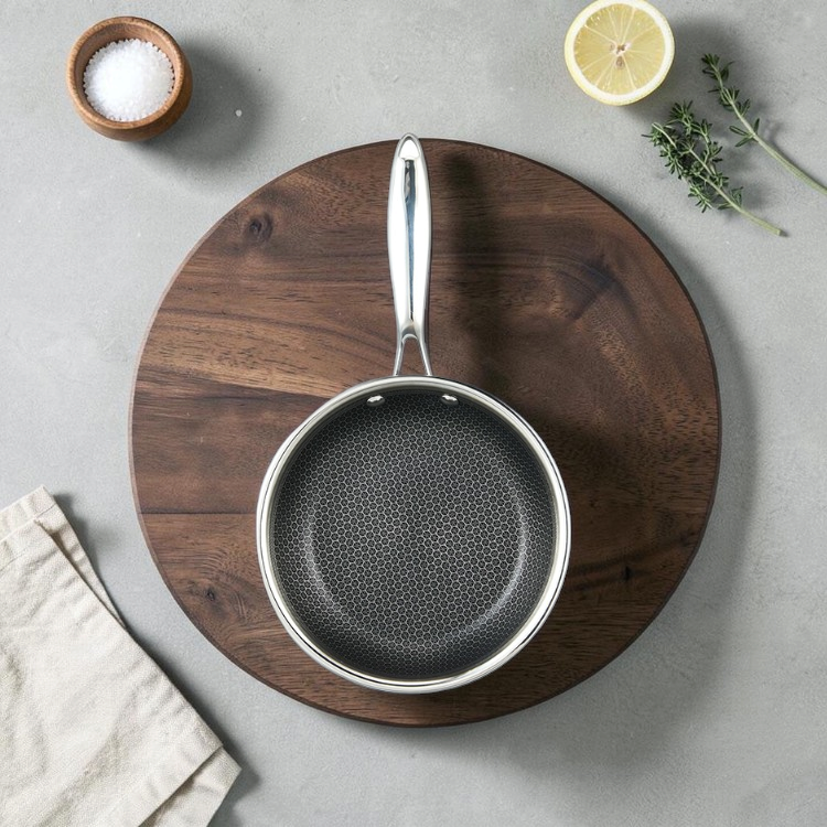 Ostrera 28 cm stainless steel hybrid frying pan with a durable honeycomb non-stick surface and ergonomic handle